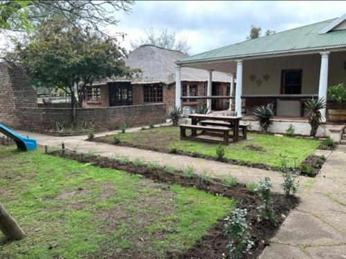 a house with a picnic table in the yard at Roydon Reserve in Queenstown