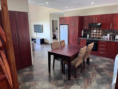 a kitchen with a wooden table and chairs at Roydon Reserve in Queenstown