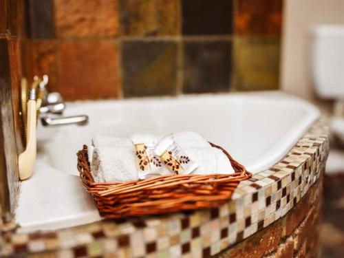 a basket of towels sitting on a bathroom sink at Roydon Reserve in Queenstown