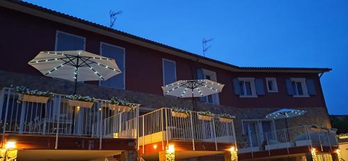 a building with umbrellas on a balcony at night at homeliday ACTIVE in Caldana