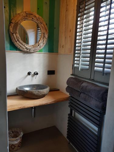 a bathroom with a sink and a mirror at Wellnessloft A Winters Tale in Dieverbrug