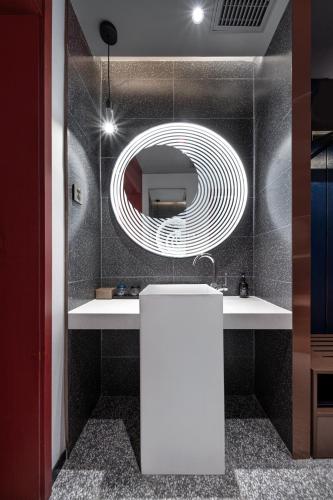 a bathroom with a sink and a mirror at Jinglai Hotel Light Luxury - Daning International Shanghai Business School Branch in Shanghai