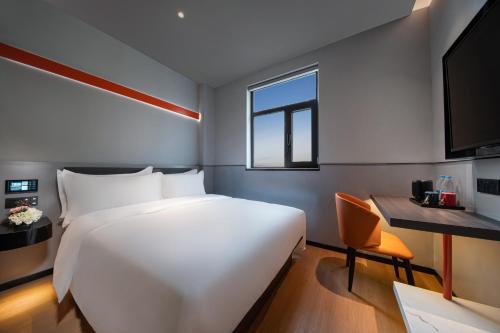 a large white bed in a room with a window at Jinglai Hotel Light Luxury - Daning International Shanghai Business School Branch in Shanghai