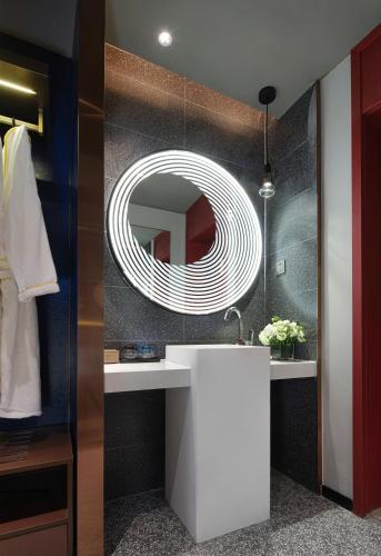 a bathroom with a white sink and a mirror at Jinglai Hotel Light Luxury - Daning International Shanghai Business School Branch in Shanghai