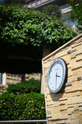 a clock on the side of a brick wall at Monteverde Hotel in Beit Meri