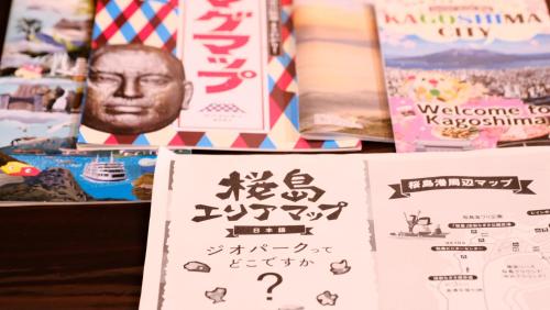 a display of books with chinese writing on them at ゲストハウス桜月荘 in Kagoshima