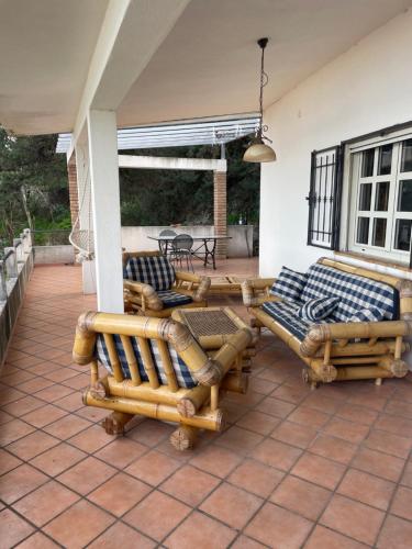a patio with couches and chairs on a porch at Casa Aurora in Copanello