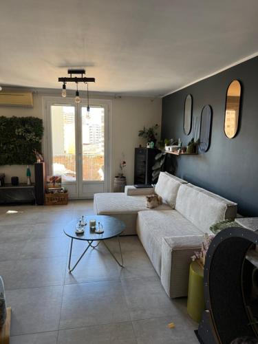 un salon avec un canapé et une table dans l'établissement Appartement rénové Toulon, à Toulon