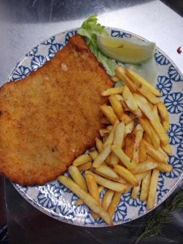 a plate of food with french fries on a table at Tenuta Torre Diana in Mordano