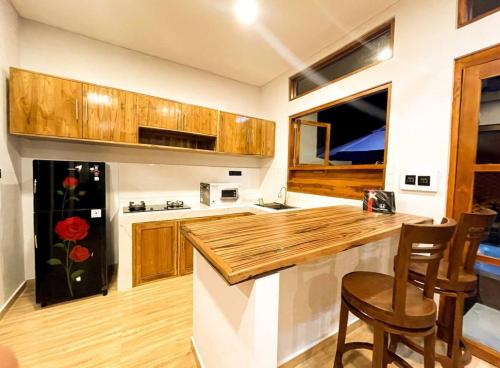 a kitchen with wooden cabinets and a counter top at Villa Nuansa Indah 2BR UNGASAN in Uluwatu