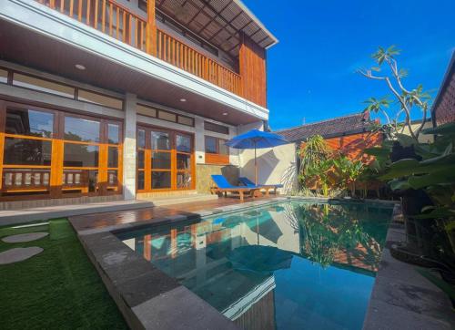 a house with a swimming pool in front of a house at Villa Nuansa Indah 2BR UNGASAN in Uluwatu