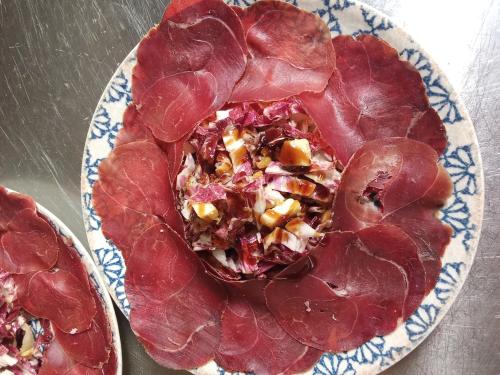 a plate of food with meat on a table at Tenuta Torre Diana in Mordano