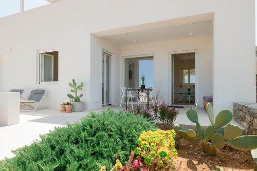 a patio with plants and a table in a house at Noble 7 Suites - Adults Only - Onar Hotels Collection in Parikia