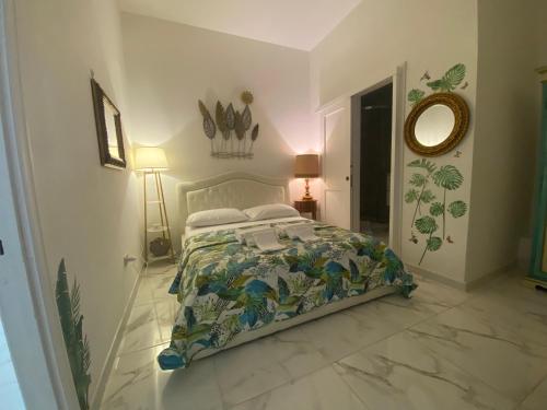 a bedroom with a bed and a mirror on the wall at Da Tea in San Teodoro