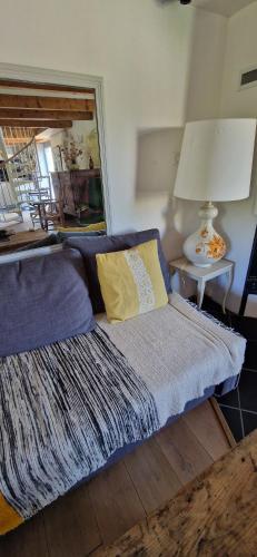 a room with a bed with a lamp and a table at La maison du vigneron in Auzon