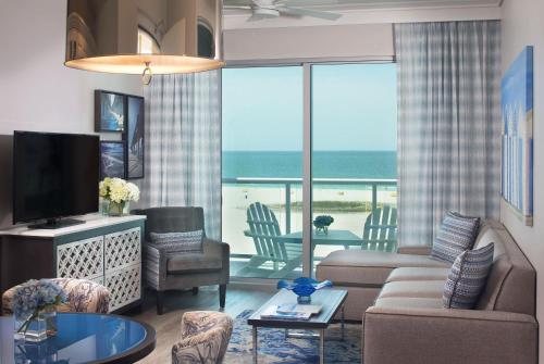 a living room filled with furniture and a tv at Treasure Island Beach Resort in St Pete Beach