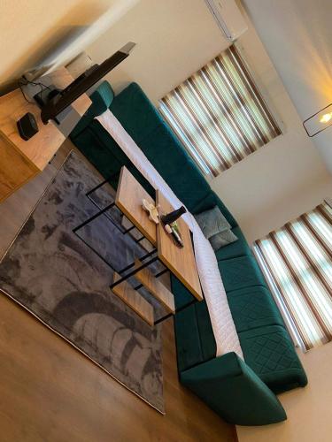 a green couch sitting in the middle of a room at Grain of Salt 