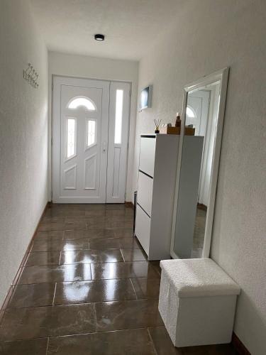 a hallway with a white door and a mirror at Grain of Salt 