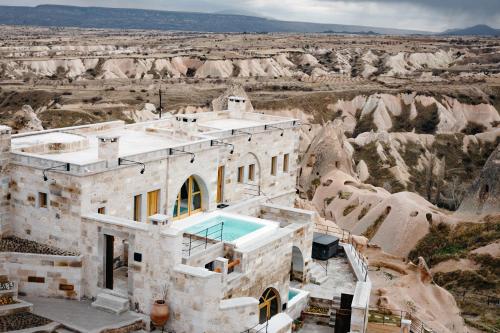 an aerial view of a house in the desert at Millstone Cave Suites Hotel in Uchisar