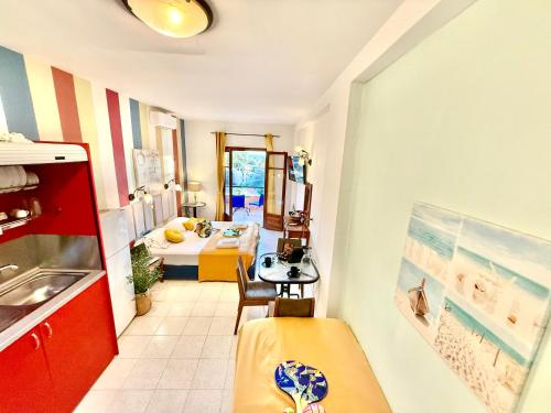 a room with a kitchen and a dining room at TRAVELLERS BEAUTIFUL ELEN Agios Gordios Sea in Agios Gordios