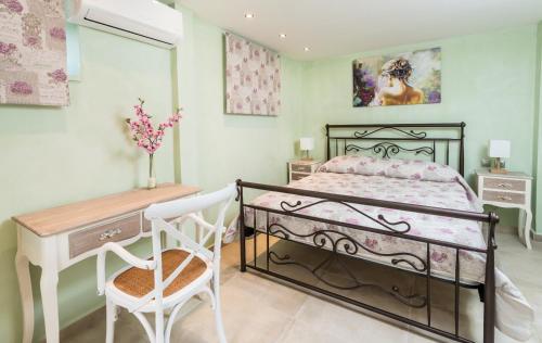 a bedroom with a bed and a desk and a chair at Villa Callisto- Elegant Restored Villa with Pool in Yírion