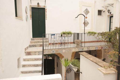 a staircase in a building with a green door at Le Porte del Tempo in Mazara del Vallo