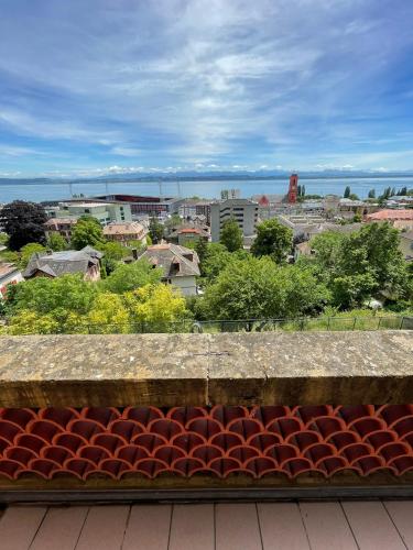 a bench sitting on top of a building overlooking a city at Bellavista in Neuchâtel