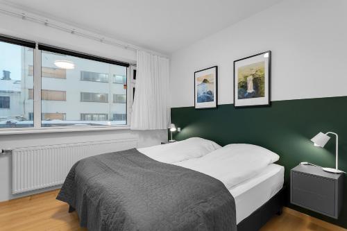 Ένα ή περισσότερα κρεβάτια σε δωμάτιο στο Centrally located modern 1BR Apartment Reykjavik