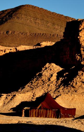 a red tent in the middle of a desert at Campement Akka Nait Sidi - Tissint in Tissint