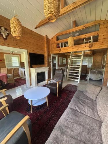 a living room with a couch and a table at Koljonvirta Cottages in Iisalmi