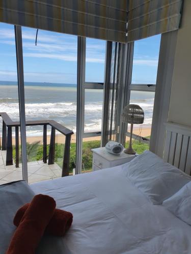 a bedroom with a bed and a view of the ocean at Sunrise Beach 6 in Westbrook