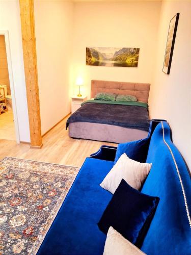 a bedroom with a bed and a couch at Apartments Romantic and Family Room Zemlinski in Payerbach