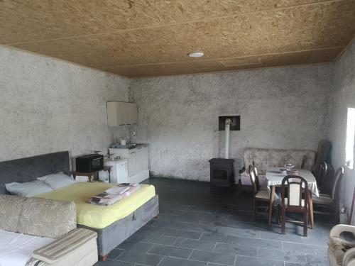 a bedroom with a bed and a table and chairs at Apartman Žabljak Crnojevića in Žabljak
