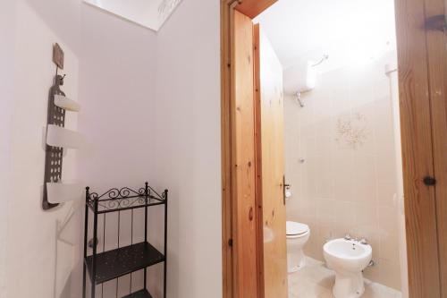 a bathroom with a toilet and a sink at Trullo La Dolce Kuki in La Correggia