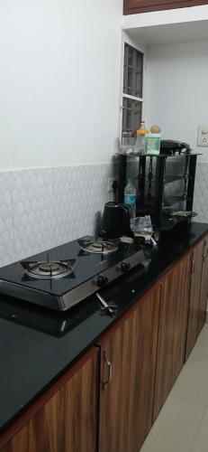 a kitchen counter with a stove top on top of it at annies inn homestay in Cochin