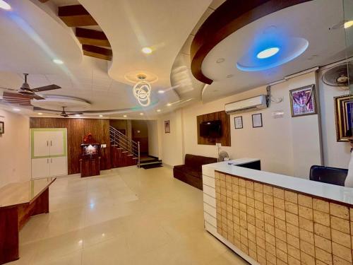 a living room with a lobby with a blue ceiling at Hotel Rising Star in Ghaziabad
