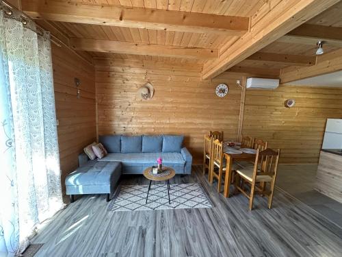 a living room with a blue couch and a table at Resort Dudukovic 1 in Slunj