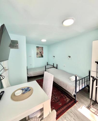 a room with a bed and a table with a tableablish at Apartmani Sara Banja Vrujci in Gornja Toplica