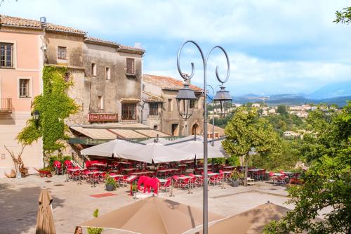 a group of tables and chairs in front of a building at Grimaldi in Cagnes-sur-Mer