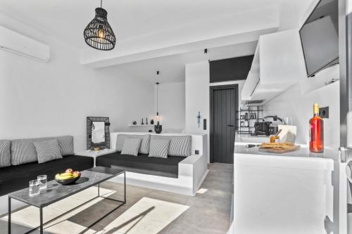 a living room with a couch and a table at Amenti Horizon View in Agkidia