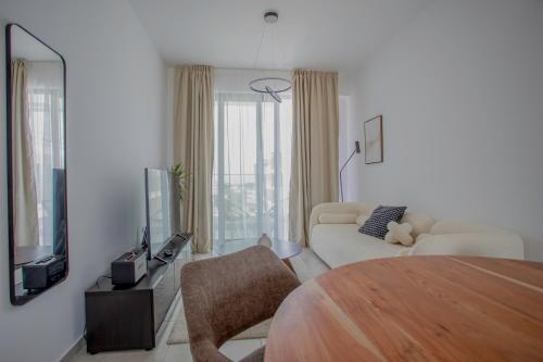 a white living room with a couch and a tv at Sea view Penthouse Universal Residences in Nea Paphos