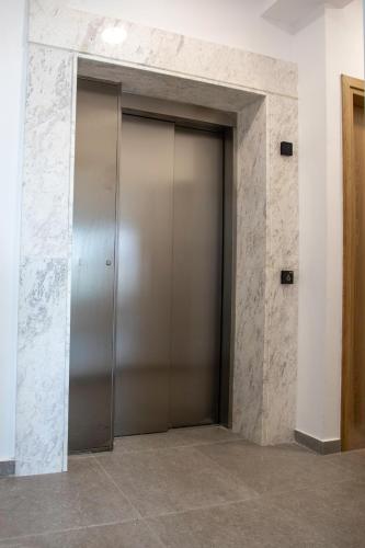a metal elevator door in a building at Sea view Penthouse Universal Residences in Nea Paphos