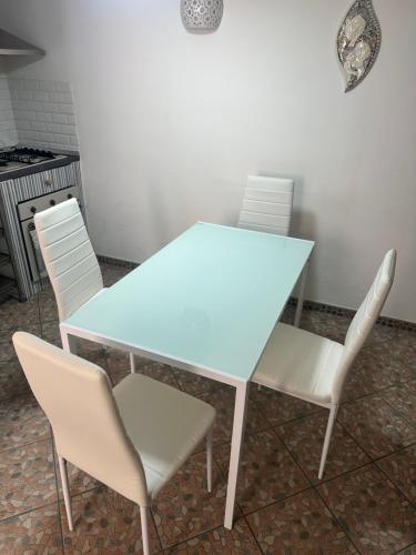a white table and chairs in a kitchen at Itaca in Lipari