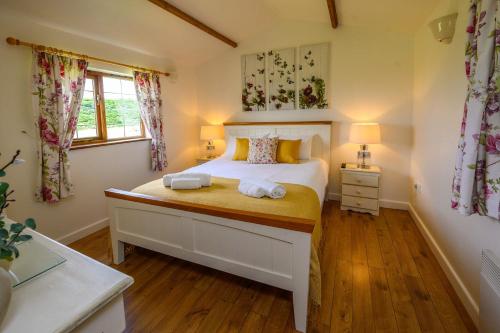 a bedroom with a bed with two towels on it at Lavender - Delightful Stables Conversion By STAE-Homes in Bristol