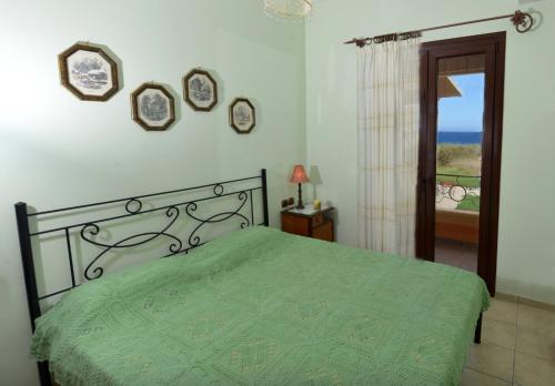 A bed or beds in a room at Galini Beach Villa