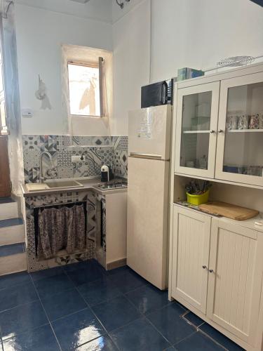 a kitchen with a stove and a sink and a refrigerator at Poseidone 2 in Lipari
