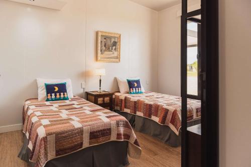 a room with two beds and a window at La Casa de Cristal by Puerto Dijama in Carmelo