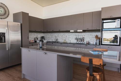 a kitchen with stainless steel appliances and a counter at La Casa de Cristal by Puerto Dijama in Carmelo