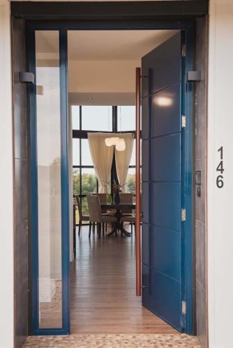 a glass door leading into a dining room with a table at La Casa de Cristal by Puerto Dijama in Carmelo