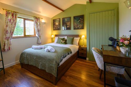 a bedroom with a bed with two towels on it at Rose - Delightful Stables Conversion By STAE-Homes in Bristol